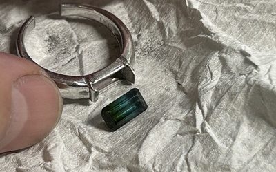 切断されたリング枠から安全に取り外された長方形のグリーントルマリン